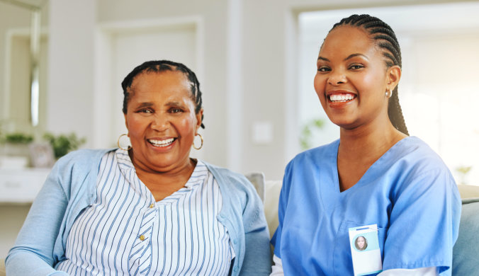 female caregiver with an elderly woman smiling