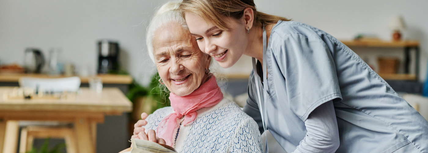 female caregiver with an elderly woman smiling