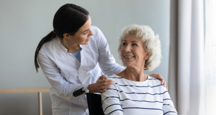 female caregiver smiling at an elderly woman