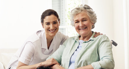 female caregiver with an elderly woman smiling