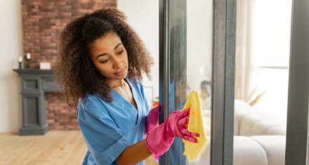 female caregiver wiping a glass window