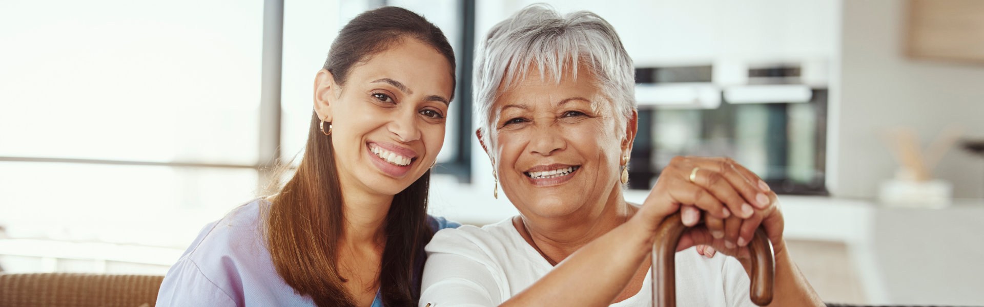 female caregiver with an elderly woman smiling